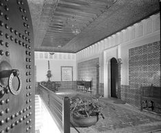 an ornately decorated entryway with decorative tile and ironwork on the walls, in black and white