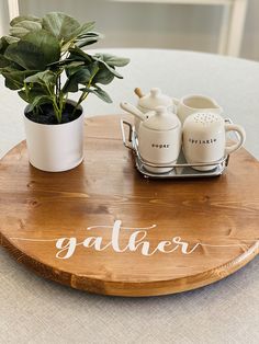 there is a potted plant on top of a wooden tray with the word gather