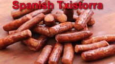 some sausages are on a wooden table with the words spanish txistora above them