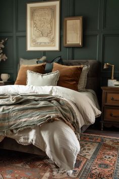 a large bed sitting next to a wooden dresser in a room with dark green walls