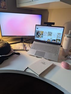 an open laptop computer sitting on top of a white desk