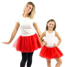 two girls in red and white tutu skirts posing for the camera