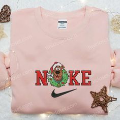 Introducing the Nike x Scooby Doo Christmas Wreath Embroidered Sweatshirt, a perfect blend of festive cheer and athletic style. This limited-edition sweatshirt showcases a meticulously crafted wreath embroidered with iconic Nike and Scooby Doo elements. Made with premium materials, it offers exceptional comfort and durability. With its unique design, this sweatshirt is a standout piece that brings joy to any holiday gathering. Whether you’re a Scooby Doo fan or simply looking for a unique Nike Inspired, Grinch Hand, Pink Coffee Cups, Maroon Hoodie, Shirt Nike, Family Christmas Gifts, Hoodie Material, Custom Nikes, Embroidered Clothes