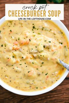 a white bowl filled with cheeseburger soup on top of a wooden table