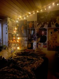 a bed room with a neatly made bed and lots of pictures on the wall