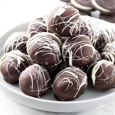 a white plate filled with chocolate covered cookies