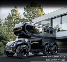 an off - road vehicle is parked in front of a building with large tires on it