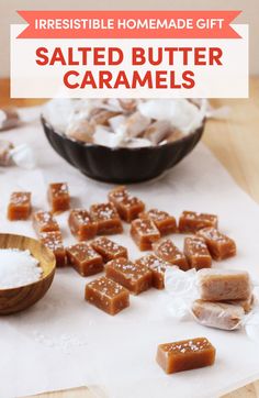 salted butter caramels on a cutting board next to a bowl of sugar