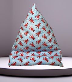 a blue and red pillow sitting on top of a white table