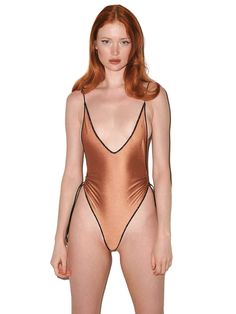 Dive into sophistication with the Calypso One Piece by Seashell, a captivating swimsuit that combines a high-cut silhouette with a daring plunging neckline. This swimwear seamlessly merges bold design elements for a striking and confident look, featuring versatile delicate strings and gold embellishments.
 Size: M, XL, XXL, L, S High Cut Boned Swimwear For Summer, High Cut Swimwear For Beach Season, Low-cut Lined Bodysuit For Beach, Low-cut Lined Bodysuit For The Beach, Beach One-piece Bodysuit With Boning, High Cut Beach Swimwear With Boning, High Cut Swimwear With Boning For Beach, Backless Evening Swimwear For Summer, Evening Backless Swimwear For Summer