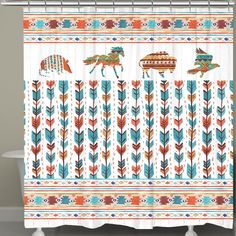 the shower curtain is decorated with native art