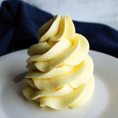 a white plate topped with sliced apples on top of a blue cloth next to a fork