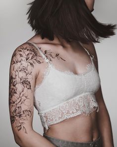 a woman with tattoos on her arm and shoulder