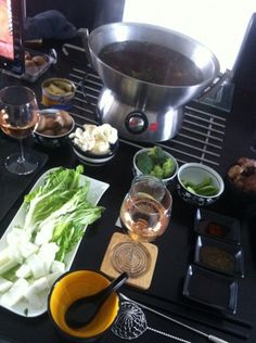 an assortment of food and wine on a table