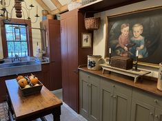 an old fashioned kitchen with a painting on the wall