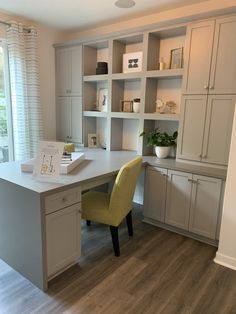 a desk with a yellow chair in front of it