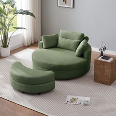 a living room with a green chair and ottoman on the floor next to a potted plant