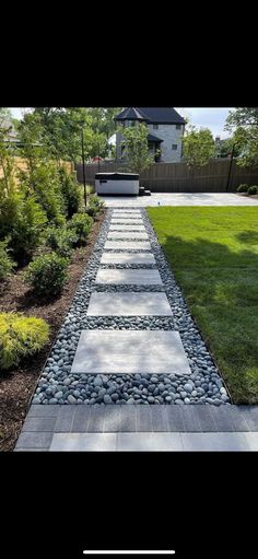 a stone path in the middle of a yard