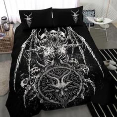 a bed covered in black and white artwork with skulls on the head, spider legs