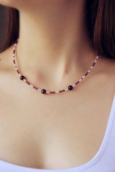 This dainty simple choker necklace was made of burgundy and pink seed beads, 3 natural garnet stone 8 mm beads, silver tone base clasps, strong double nylon thread, silver tone lobster claw and stainless steel adjustable length chain. The length of necklace is about 41.5 cm or about 16.3 inches. The necklace has an adjustable chain. The length is 4.5 cm or 1.5 inches. Other necklaces of my shop you can see here: https://www.etsy.com/shop/NaTavelli?section_id=14843046&ref=shopsection_leftnav_ Wooden Beads Choker Beaded Necklaces For Gifts, Simple Choker Necklace, Green Choker, Simple Choker, Beads Choker, Boho Choker, Garnet Jewelry, Everyday Necklace, Garnet Stone