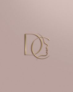 a woman's face is shown with the letter d in gold on a pink background