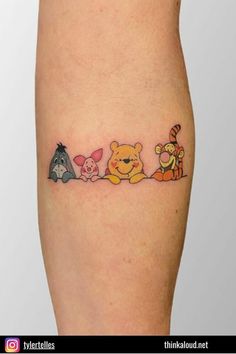 a small tattoo with winnie the pooh and friends on it's leg,