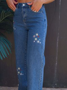 Embroidered Flower Straight Leg Retro High-Rise Waist Hippie Cotton Denim Jean Pants When it comes to denim pants these 60s retro style classic jeans have it all.Made of 100% cotton with a beautiful embroidered multicolored floral addition that is perfect for achieving an effortlessly cool vintage aesthetic.High-rise waist offers style, comfort and functionality while creating an elongated silhouette that enhances your curves while preventing muffin top.Straight wide leg style adds a classic and timeless touch to any outfit, offering extra room for movement.Equipped with functional pockets, the belt loops offer the option to accessorize for a personalized touch. Details: Color: Blue, White, Yellow, Pink Rise: Hi-Rise Hem: Wide Closure: Zipper, Button Material: 100% Cotton Care instructions Things To Embroider On Jeans, Hand Embroidered Jeans, Embroidery Jeans Ideas, Hand Embroidery Jeans, Koti Design, Thrifting Manifestation, Nature Clothes, Jeans Embroidery, College Clothes