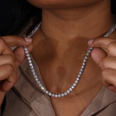 This Diamond Tennis Necklace is a beautiful statement piece made with 4.0 MM Round Lab Grown Diamonds on a Tennis Chain. Show your unique style with this eye-catching and elegant diamond necklace. "𝐓𝐨𝐠𝐞𝐭𝐡𝐞𝐫 𝐰𝐞 𝐜𝐚𝐧 𝐦𝐚𝐤𝐞 𝐭𝐡𝐞 𝐰𝐨𝐫𝐥𝐝 𝐚 𝐛𝐞𝐭𝐭𝐞𝐫 𝐩𝐥𝐚𝐜𝐞 𝐟𝐨𝐫 𝐥𝐢𝐯𝐢𝐧𝐠, 𝐥𝐞𝐭’𝐬 𝐠𝐨 𝐰𝐢𝐭𝐡 𝐦𝐢𝐧𝐢𝐧𝐠-𝐟𝐫𝐞𝐞 𝐝𝐢𝐚𝐦𝐨𝐧𝐝𝐬 𝐚𝐧𝐝 𝐡𝐚𝐧𝐝 𝐨𝐯𝐞𝐫 𝐚 𝐛𝐞𝐭𝐭𝐞𝐫 𝐭𝐨𝐦𝐨𝐫𝐫𝐨𝐰 𝐚𝐧𝐝 𝐜𝐥𝐞𝐚𝐧 𝐞𝐚𝐫𝐭𝐡 𝐭𝐨 𝐭𝐡𝐞 𝐜𝐨𝐦𝐢𝐧𝐠 𝐠𝐞𝐧𝐞𝐫𝐚𝐭𝐢𝐨𝐧𝐬. Dazzling Single Strand Necklace For Gift, White Gold Diamond Single Strand Jewelry, Luxury Moissanite Necklaces For Formal Occasions, Single Strand White Gold Diamond Jewelry, Luxury Moissanite Necklace With Brilliant Cut, Dazzling Single Strand Diamond Jewelry, Diamond White Single Strand Jewelry Gift, Diamond White Single Strand Round Cut Jewelry, Dazzling Diamond White Single Strand Jewelry