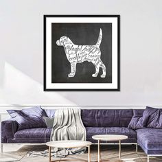 a living room with purple couches and a chalkboard drawing of a dog on the wall