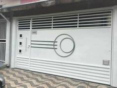 a white garage door with a circular design on it