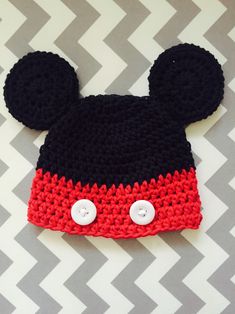 a crocheted mickey mouse hat with buttons