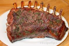 a piece of steak is sitting on a plate with some forks sticking out of it