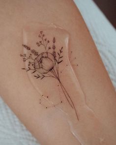 a woman's arm with a flower and heart tattoo on the left side of her arm