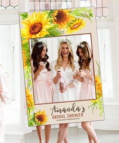 two beautiful women in white robes standing next to each other with sunflowers on them