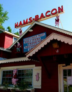 the sign for hamsbacon on top of a red building with pig figures