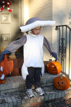 a little boy dressed up in a penguin costume