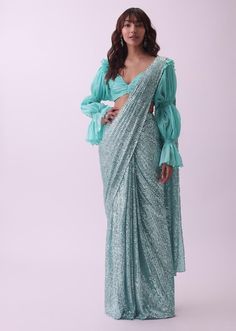 📌Hey! Please message us if you have any questions. We'll definitely assist you. Introducing the exquisite Designer Aqua Blue Pre Stitched Sequins Saree with Ruching Blouse - a stunning ensemble that seamlessly blends traditional elegance with modern flair. This ensemble is sure to turn heads and make you the center of attention at any event or occasion. Saree Description: The saree features a mesmerizing aqua-blue hue that exudes grace and sophistication. Crafted from a high-quality fabric that drapes beautifully, the saree boasts an intricate arrangement of sequins that catch the light with every movement, creating a dazzling and ethereal effect. The sequins are strategically placed to enhance the overall design and add a touch of glamour. What sets this saree apart is its pre-stitched d Fancy Sleeves, Sequins Saree, Stitched Saree, Modern Saree, Trendy Blouse, Cocktail Parties, Blue Hues, Aqua Blue, Sweetheart Neckline