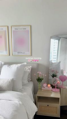 a bedroom with white bedding and pink accents