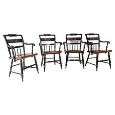 four chairs with wooden seat and backrests in different styles, all sitting side by side