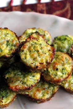 broccoli and cheese muffins piled on top of each other in a white bowl