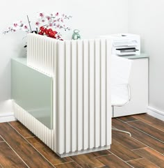 a white radiator sitting on top of a wooden floor next to a wall