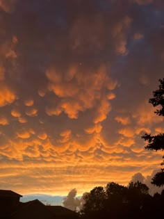 the sky is filled with clouds as the sun sets