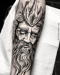 a man's forearm with a black and white tattoo design on the left arm