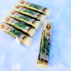 six wooden candles with the image of jesus on them