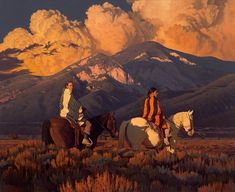 two women riding horses in front of mountains