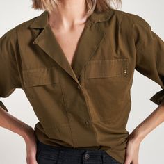 The Fay Boyfriend Shirt is roomy and relaxed but decidedly feminine and sophisticated. Crafted from cotton lawn, a lightweight yet durable fine thread poplin, the Faye has a silky-smooth hand feel. Its unique features include a lay-flat camp collar with an elevated top button and loop closure, wide-set pleated center front placket, and exquisite topstitching details on the sleeve placket and cuff. 100% Cotton Button flap patch pockets at the chest High side-slits at the hem for a fashionable tuc Spring Long Sleeve Camp Shirt With Pockets, Relaxed Fit Shirt With Roll-up Sleeves And Camp Collar, Daywear Blouse With Pockets And Spread Collar, Olive Button-up Workwear Shirt, Olive Button-up Shirt For Work, Workwear Shirt With Rolled Sleeves And Camp Collar, Effortless Workwear Blouse With Pockets, Olive Relaxed Fit Top For Work, Collared Cotton Camp Shirt