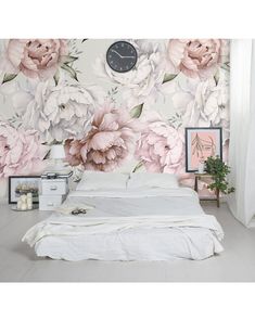 there is a large floral wall mural in the bedroom with white bedding and pink flowers on it