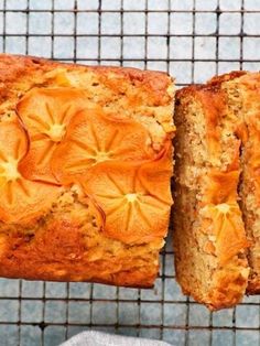 a close up of a loaf of bread on a cooling rack with slices cut off