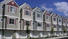 a row of multi - family houses with garages on each side