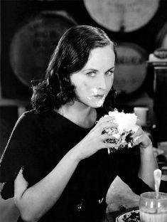 a woman sitting at a table eating food